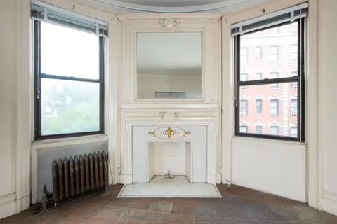 a view of a dining room with furniture and a potted plant