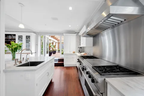 a kitchen with stove and refrigerator