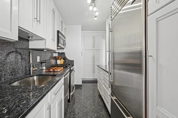 a kitchen with a sink stove and refrigerator