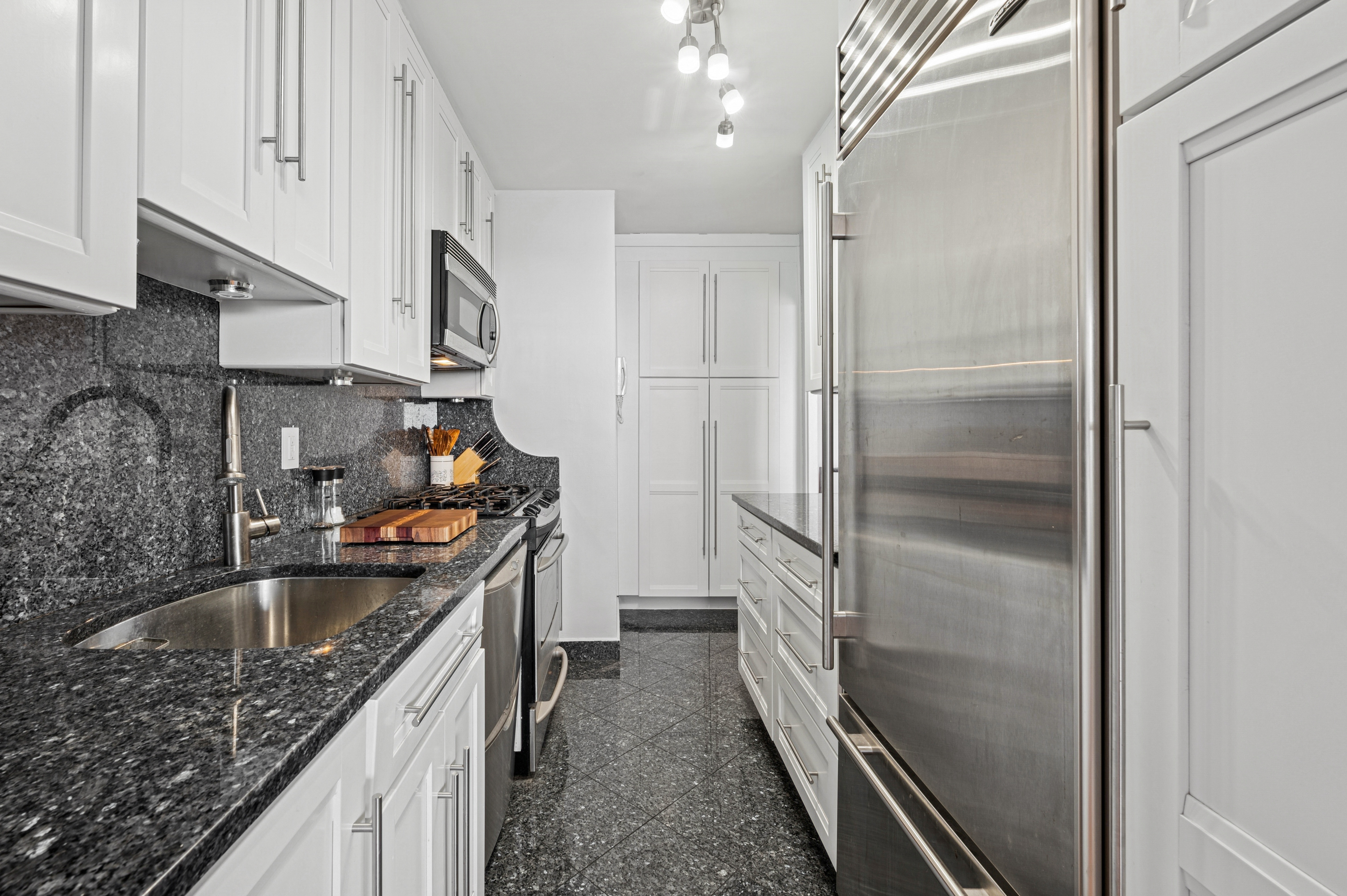 5700 Arlington Avenue, Unit 7G Bronx, NY 10471 - Photo 3 of 16 a kitchen with a sink stove and refrigerator