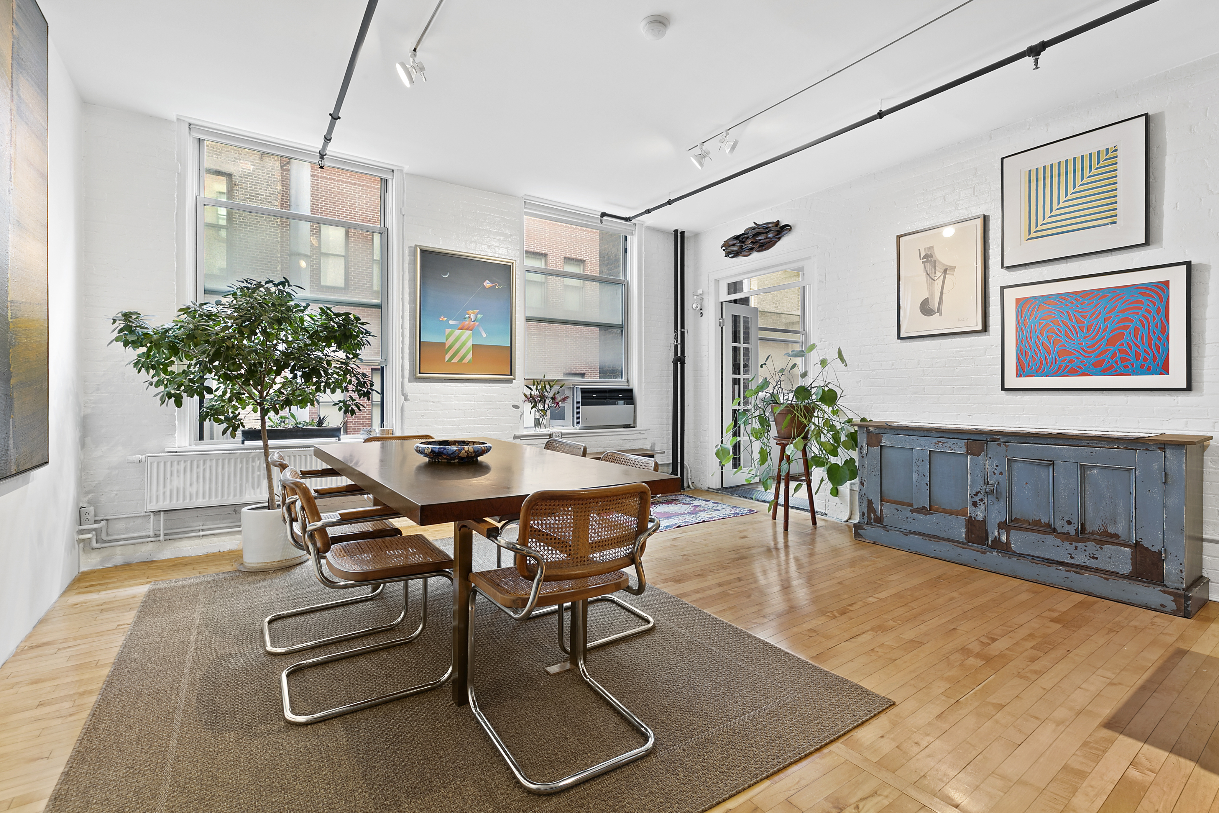 108 Wooster Street, Unit 4C Manhattan, NY 10012 - Photo 1 of 9 a dining room with furniture and window