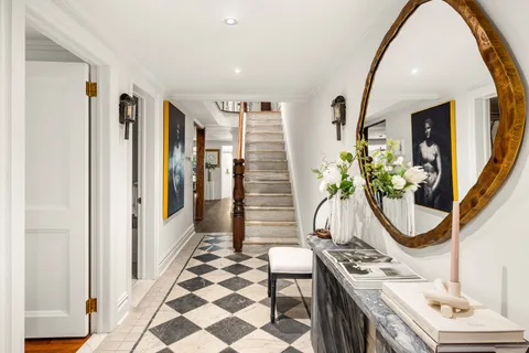 a dining room with furniture and a potted plant