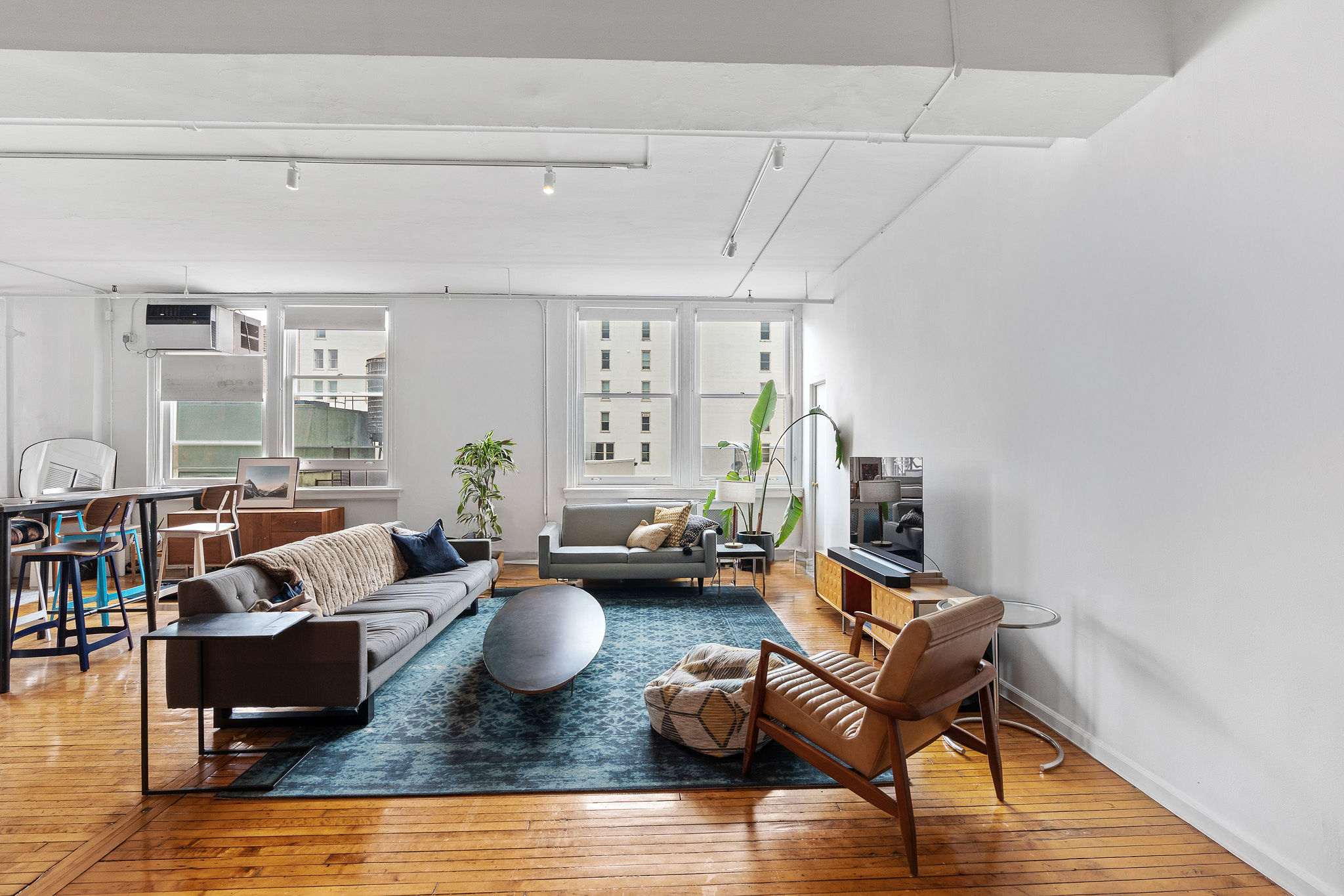 565 Broadway, Unit 8W Manhattan, NY 10012 - Photo 9 of 23 a living room with furniture and a wooden floor
