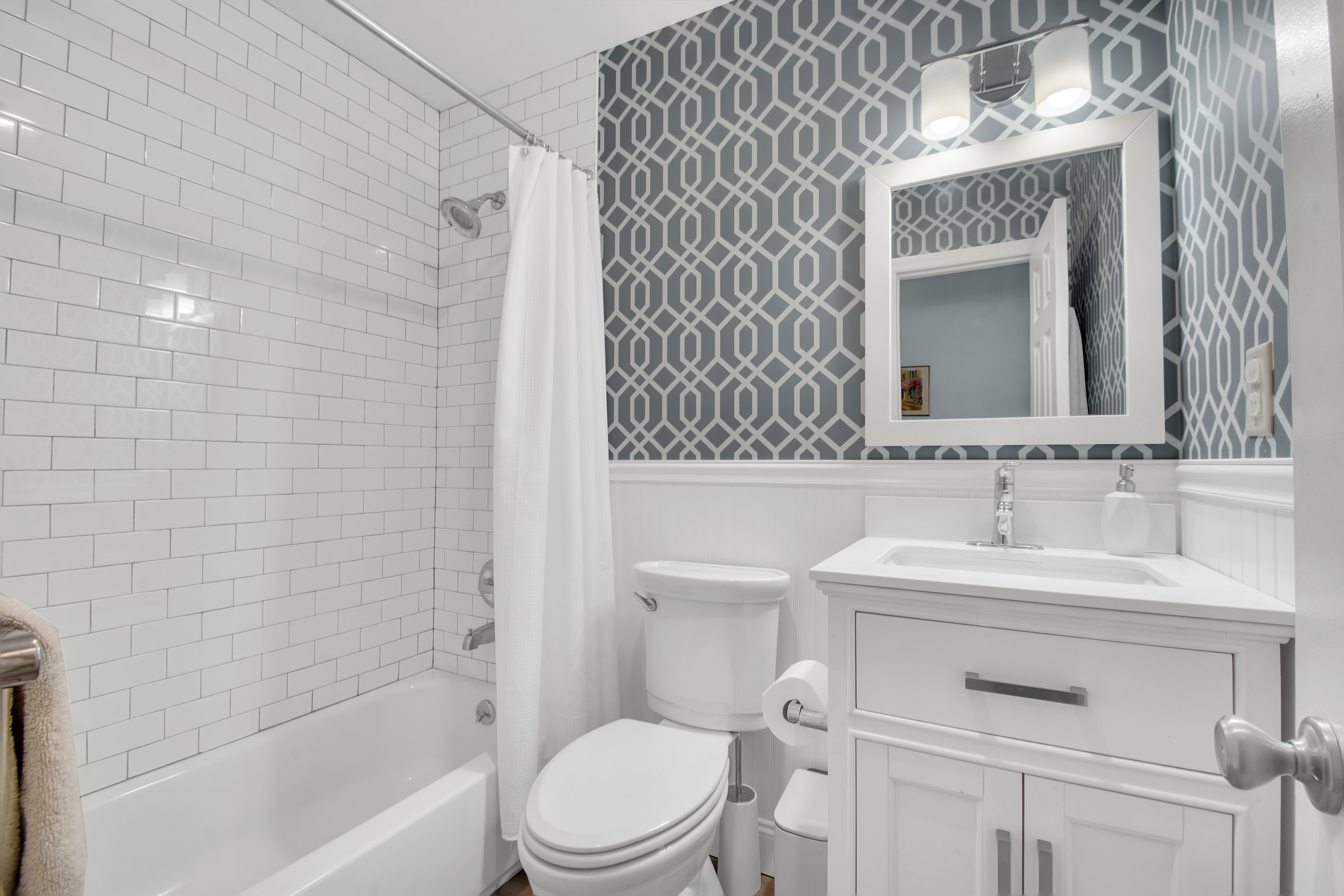 594 6th Avenue, Unit 3 Brooklyn, NY 11215 - Photo 10 of 11 a bathroom with a sink toilet vanity mirror and bathtub