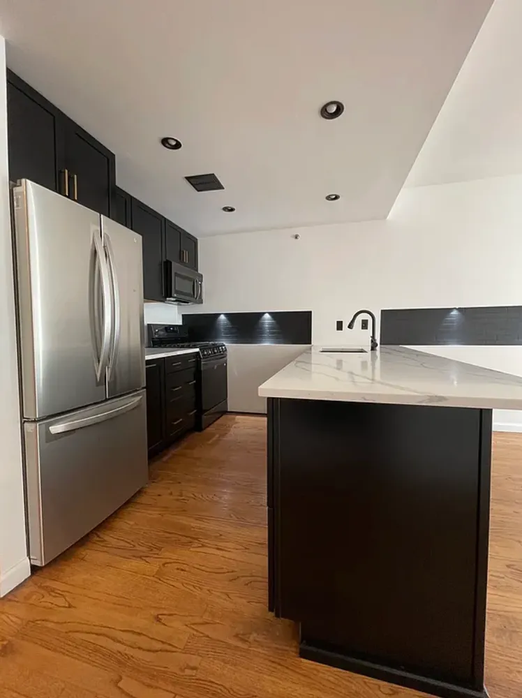 a kitchen with a refrigerator and a sink