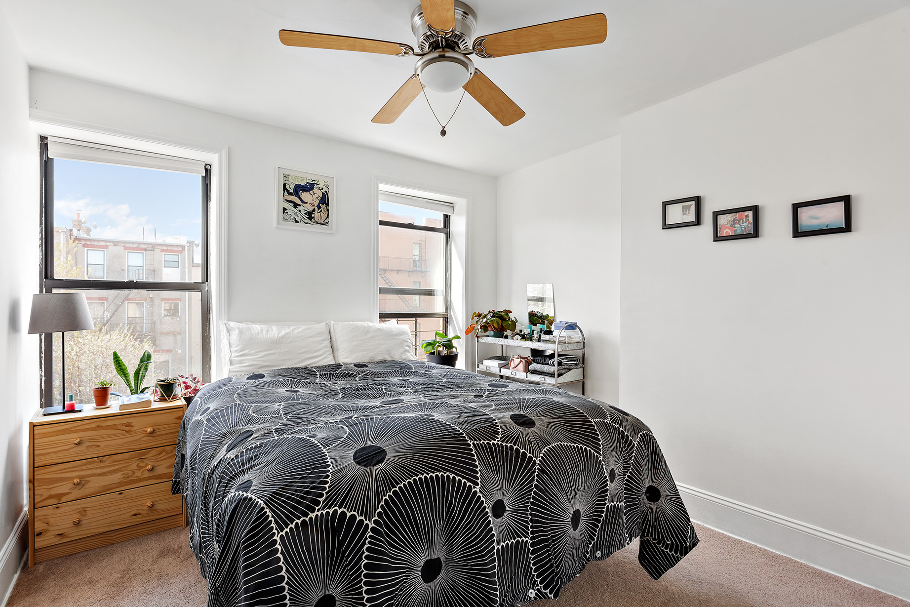 232 Monroe Street Brooklyn, NY 11216 - Photo 17 of 21 a bed sitting in a bedroom next to a window