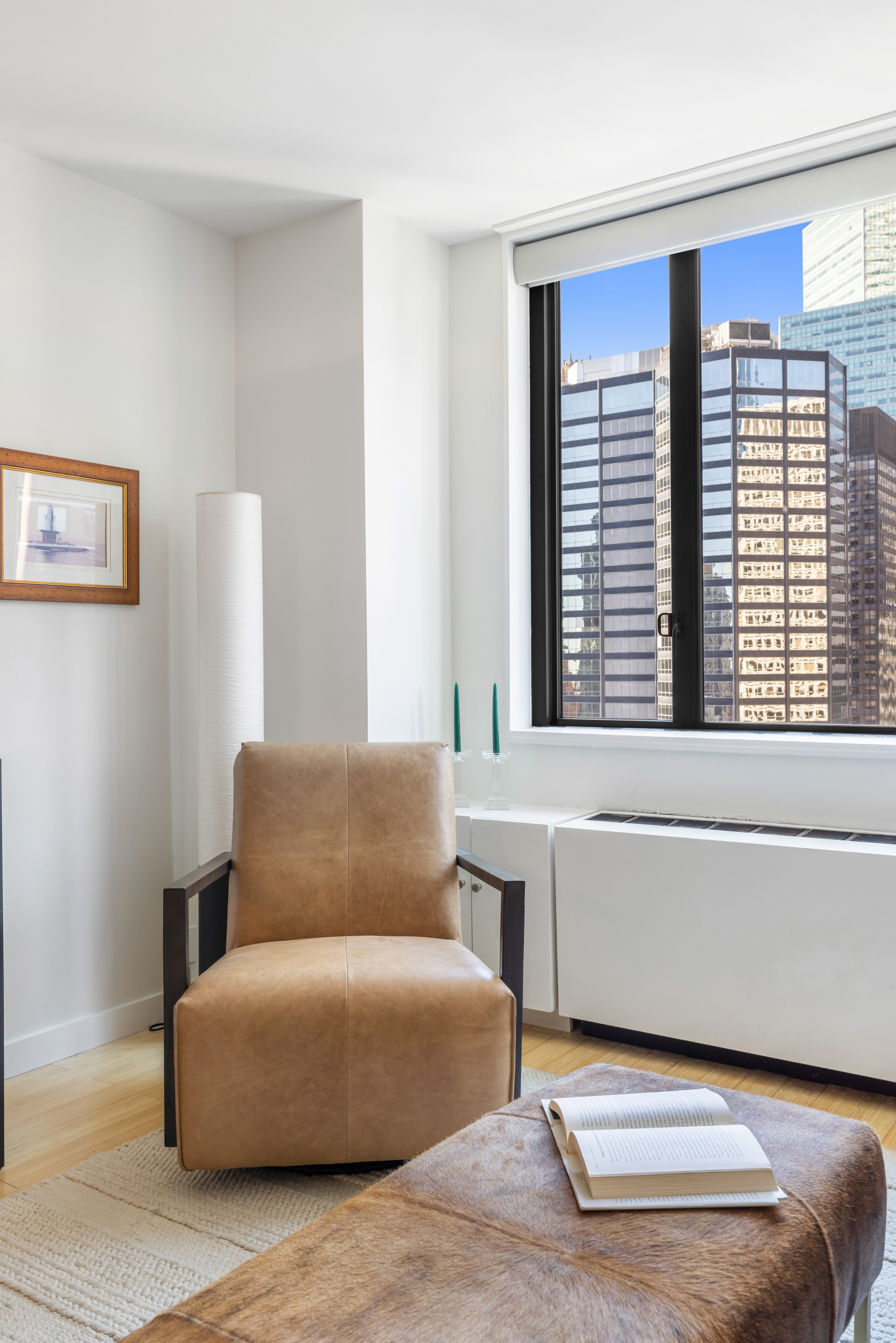 300 East 54th Street, Unit 23E Manhattan, NY 10022 - Photo 3 of 13 a living room with furniture and a window