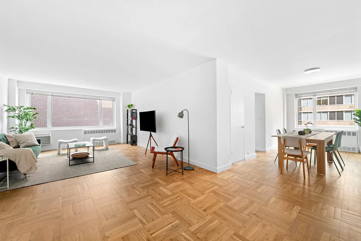 411 East 53rd Street, Unit 17A Manhattan, NY 10022 - Photo 2 of 10 a living room with furniture and a flat screen tv