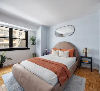 a bedroom with a large bed and windows