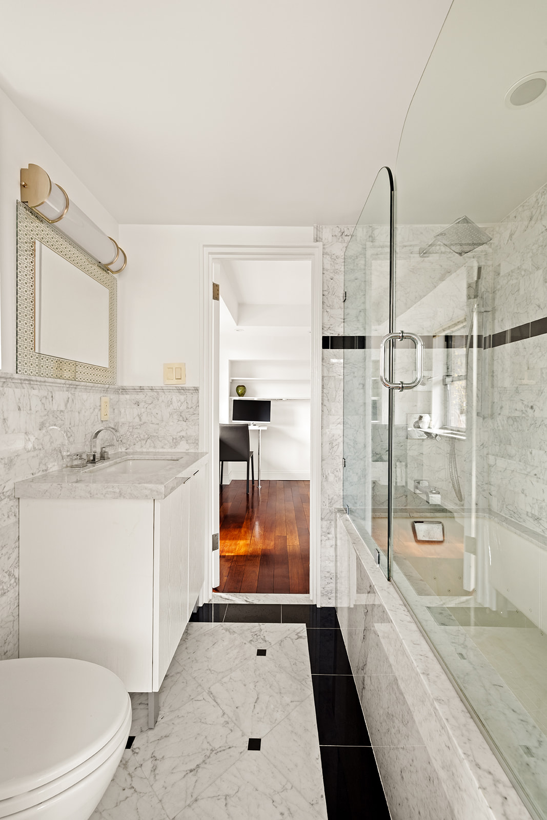 330 East 49th Street, Unit 12E Manhattan, NY 10017 - Photo 14 of 16 a bathroom with a granite countertop sink a toilet and shower