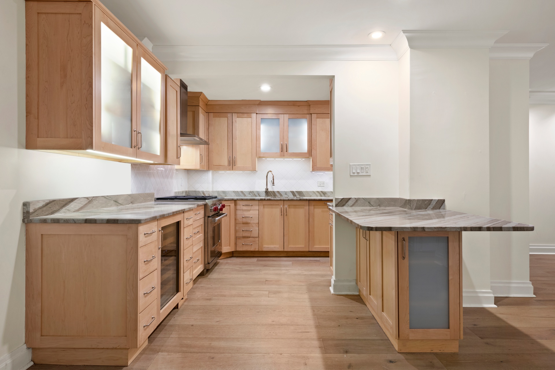 440 East 57th Street, Unit 1G Manhattan, NY 10022 - Photo 6 of 10 a kitchen with granite countertop a sink stove and cabinets