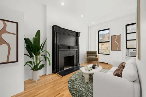 a bedroom with a bed and a potted plant