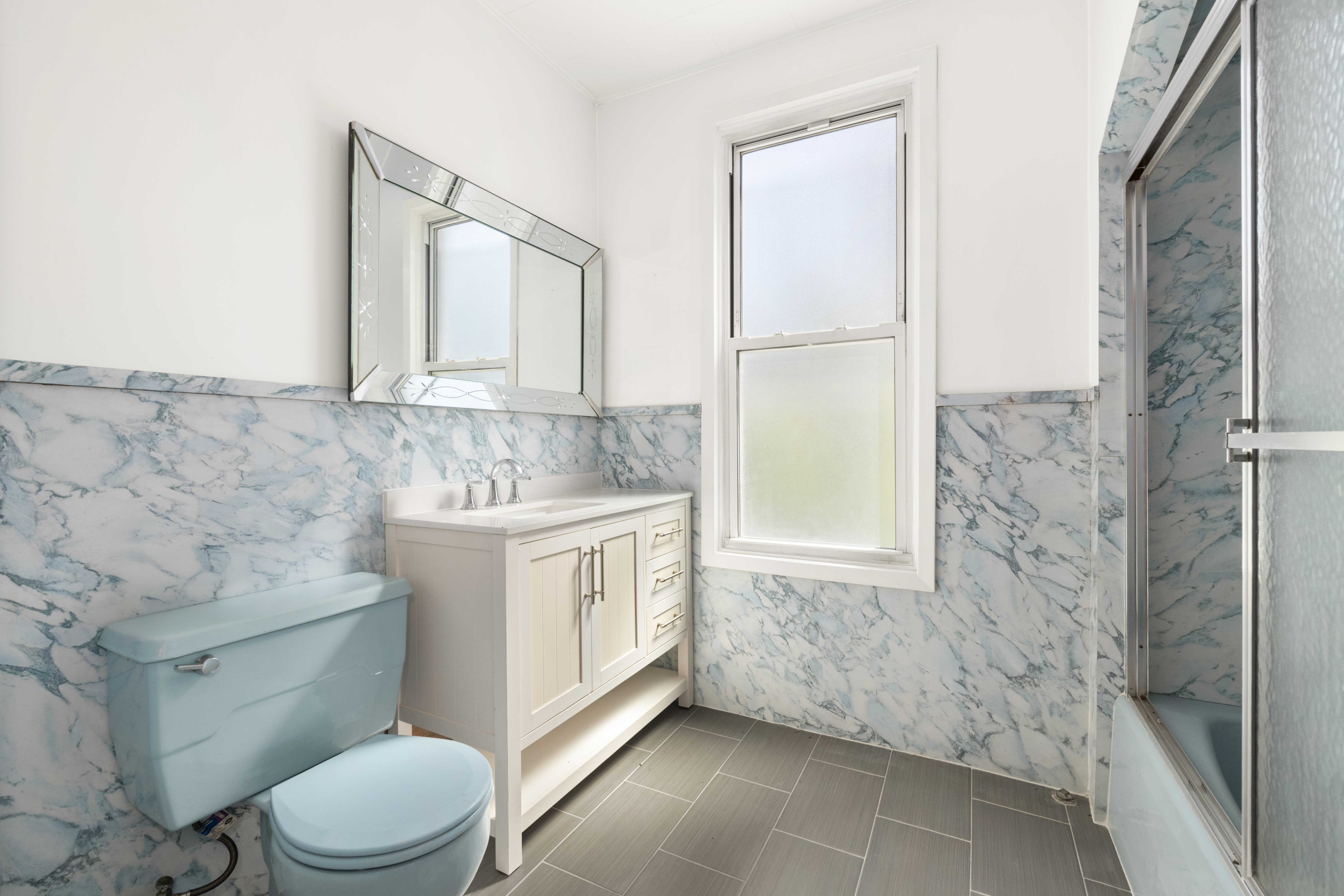 37-34 28th Street Queens, NY 11101 - Photo 12 of 17 a bathroom with a granite countertop sink toilet and shower