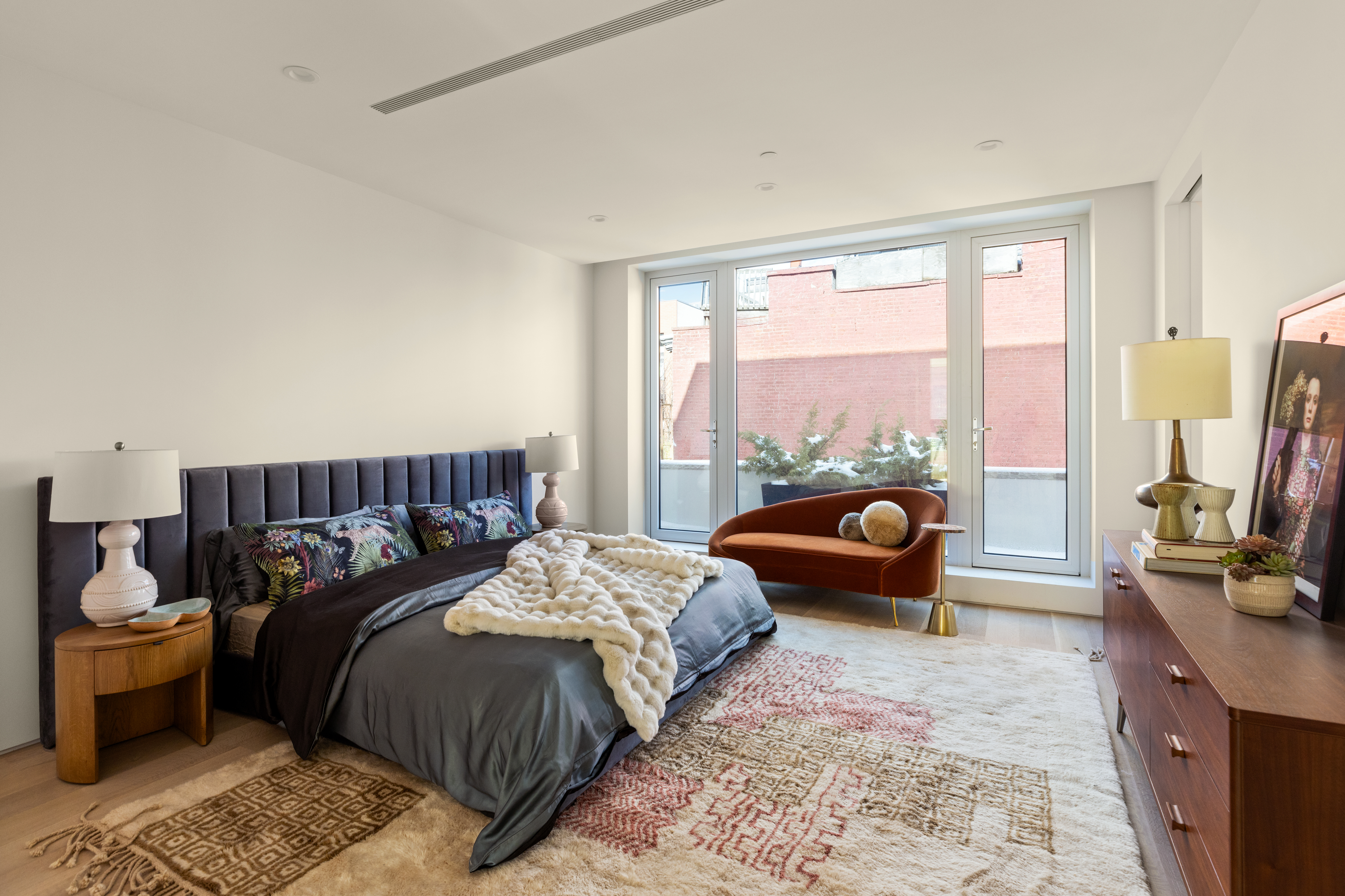 276 Berry Street Brooklyn, NY 11249 - Photo 18 of 36 a bedroom with bed couch and a large window