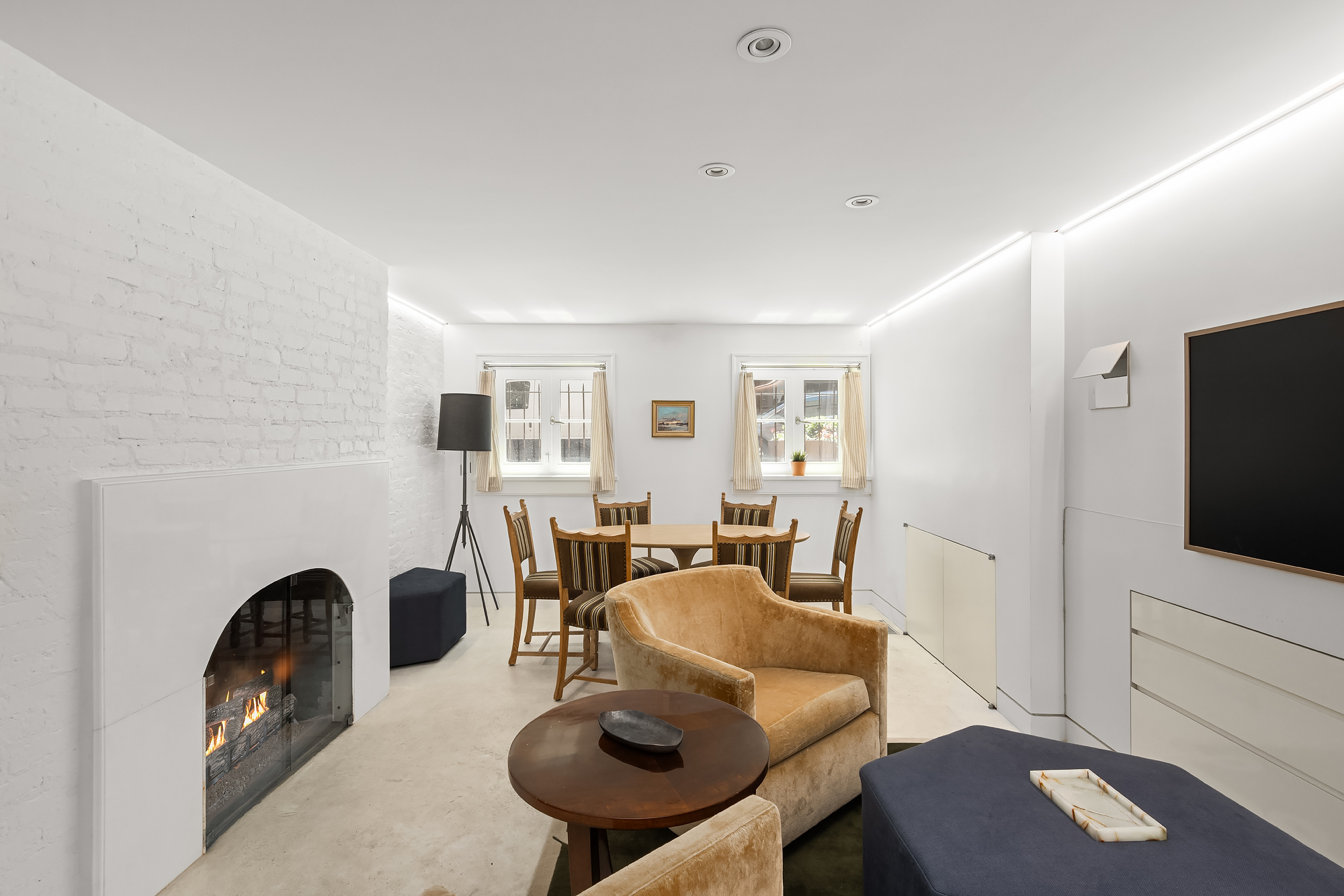21 Cornelia Street Manhattan, NY 10014 - Photo 9 of 26 a living room with furniture a flat screen tv and a refrigerator