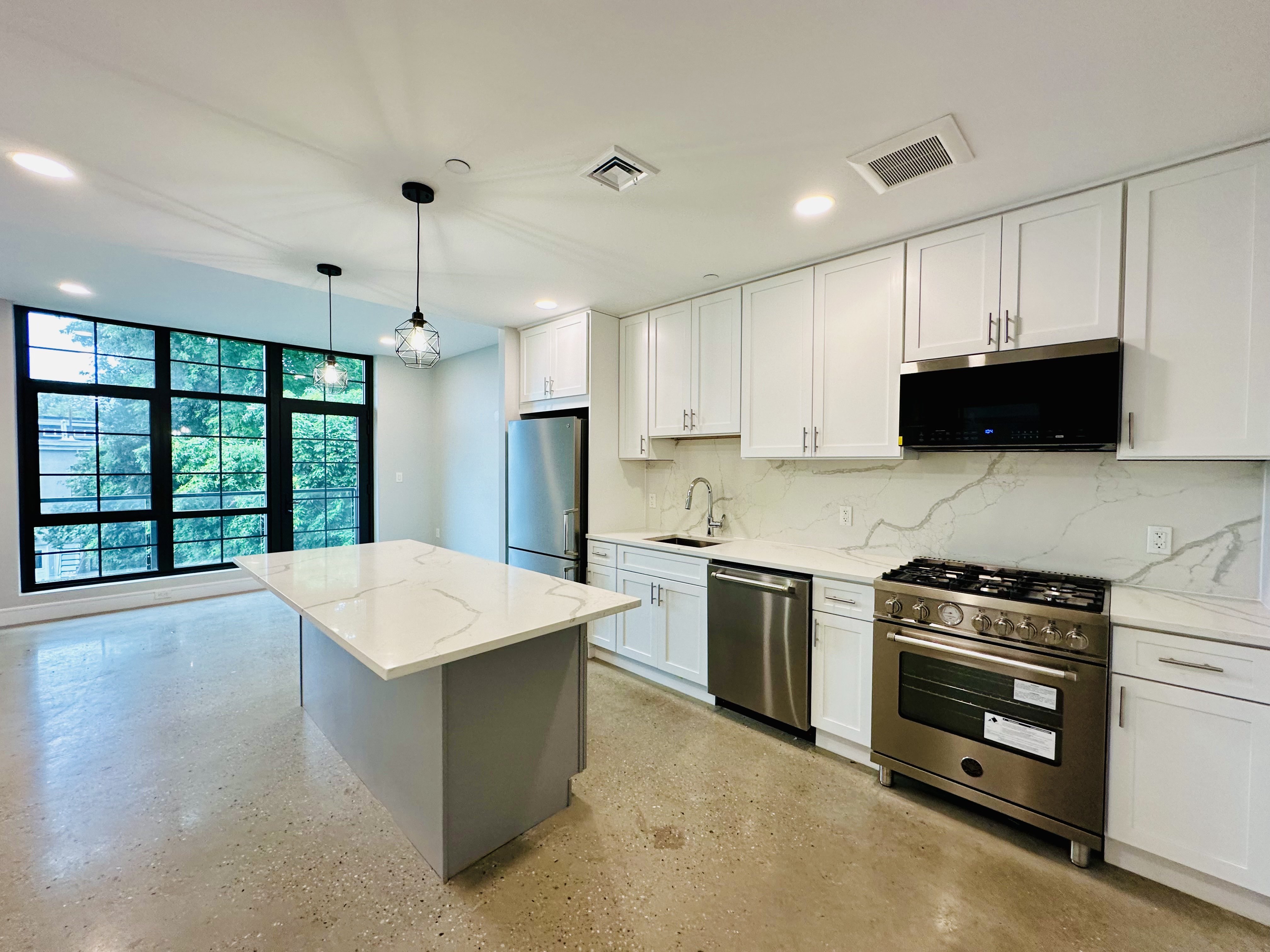 a kitchen with a stove a sink and a refrigerator