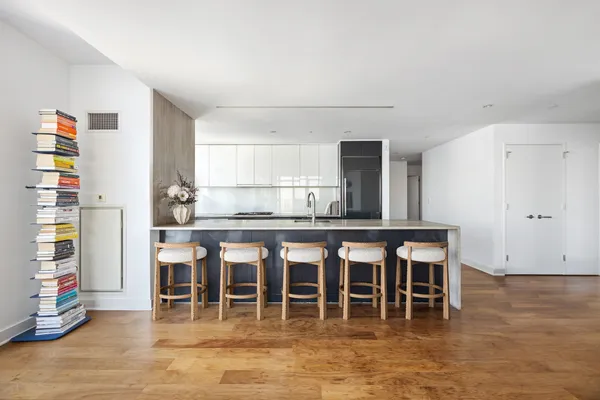 a kitchen with stainless steel appliances granite countertop a refrigerator and a stove top oven