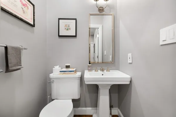a bathroom with a sink mirror and toilet