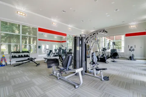 a room with gym equipment and a large window