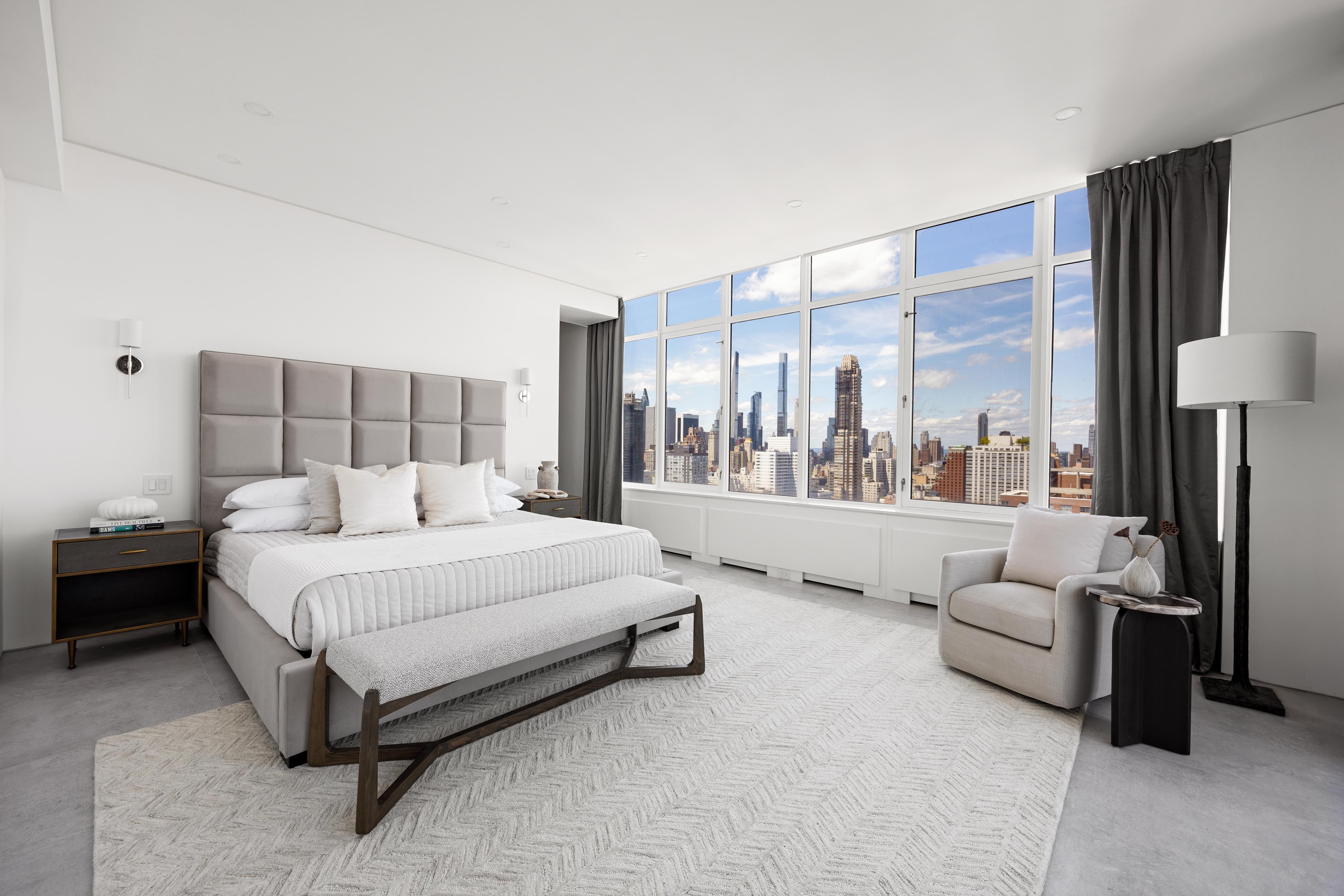 422 East 72nd Street, Unit 37AD Manhattan, NY 10021 - Photo 12 of 38 a spacious bedroom with a bed and a large window