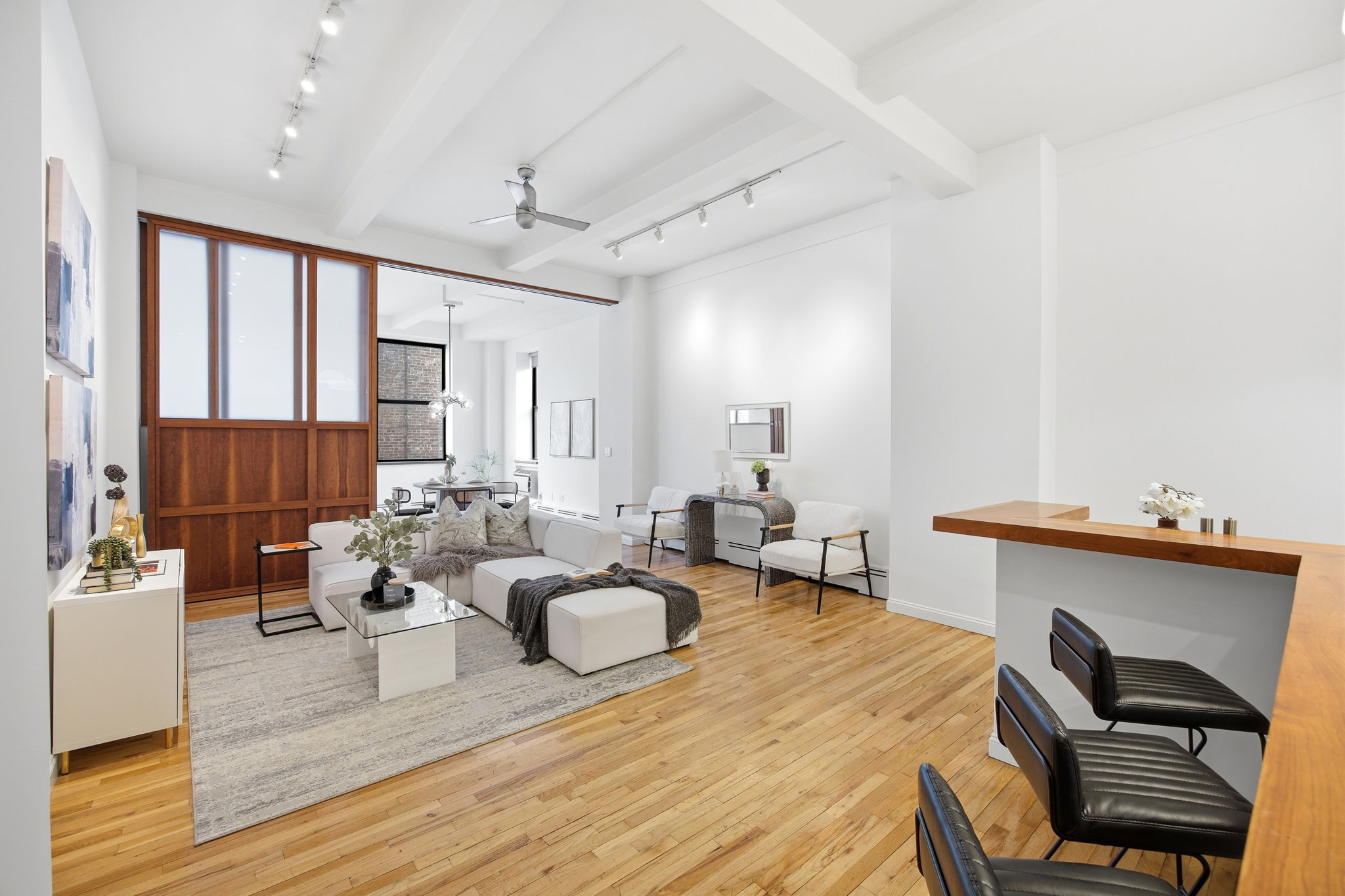 114 East 13th Street, Unit 6B Manhattan, NY 10003 - Photo 3 of 12 a living room with furniture and wooden floor