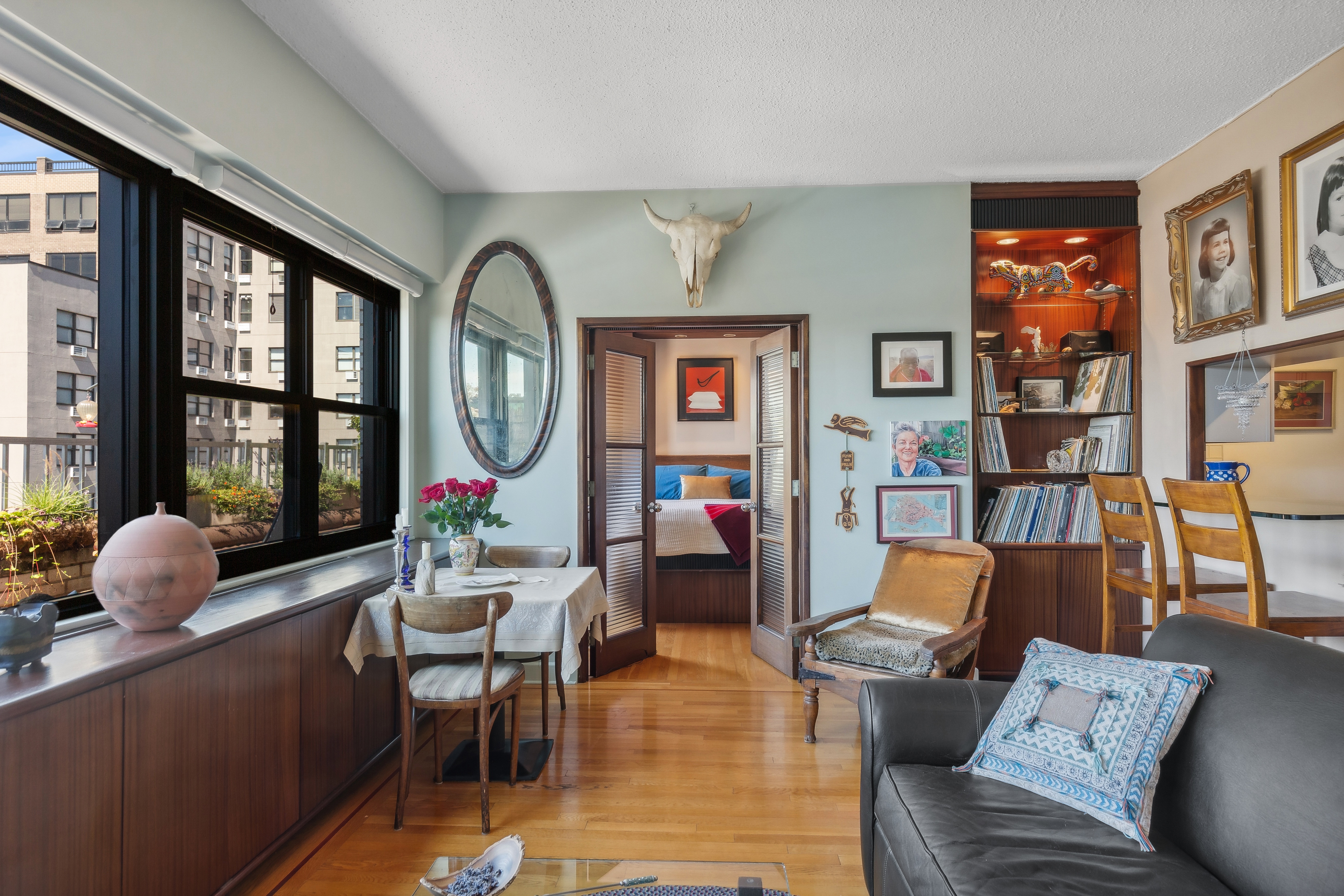 210 East 15th Street, Unit PHD Manhattan, NY 10003 - Photo 3 of 12 a living room with furniture chess floor and a large window