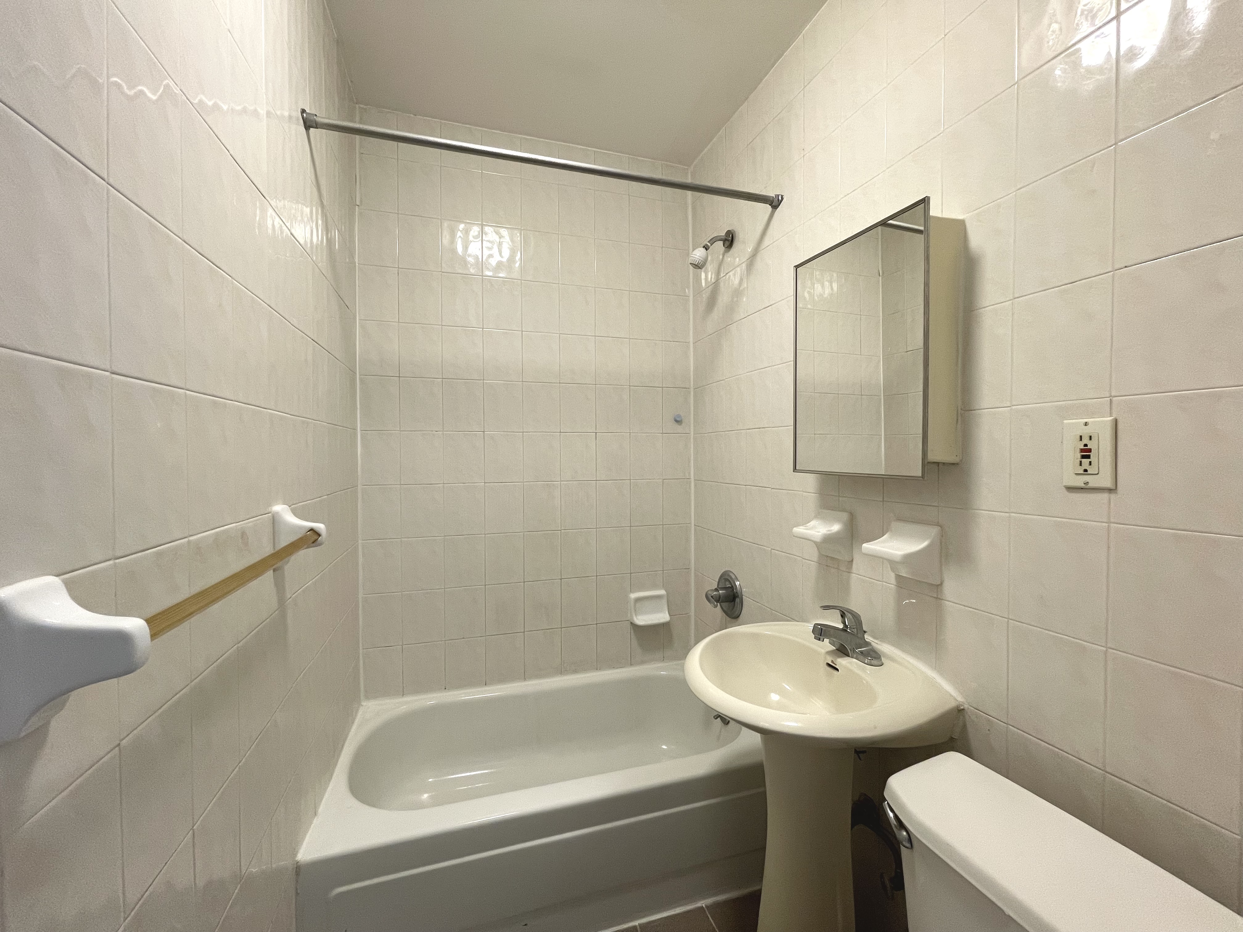 95 St Marks Place, Unit 6 Manhattan, NY 10009 - Photo 12 of 14 a bathroom with a sink toilet and shower