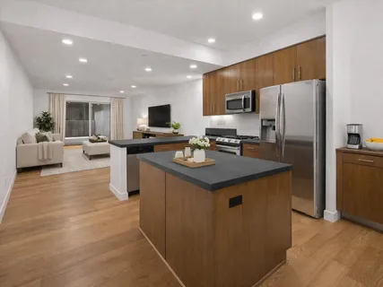 a kitchen with stainless steel appliances granite countertop a refrigerator stove microwave and sink