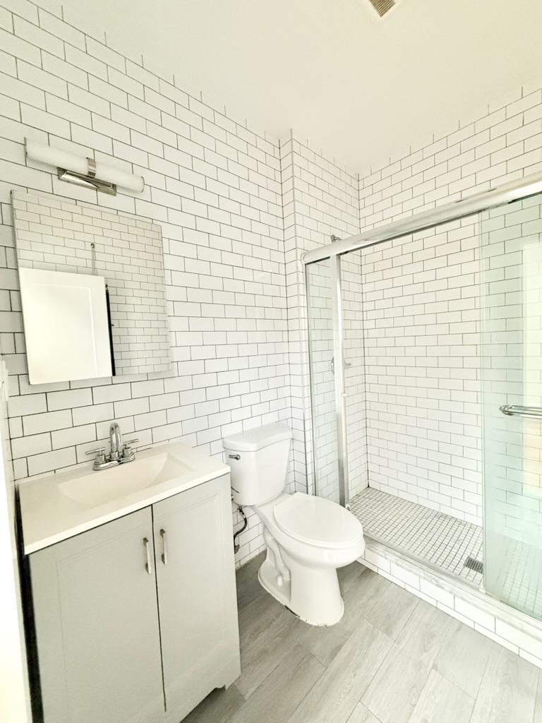 2013 Flatbush Avenue, Unit 2R Brooklyn, NY 11234 - Photo 3 of 11 a bathroom with a sink a toilet and shower