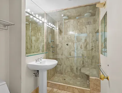 a bathroom with a shower sink and mirror