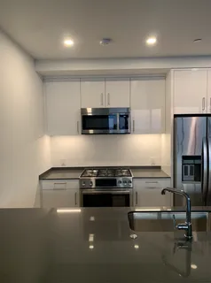a kitchen with granite countertop a stove and a refrigerator