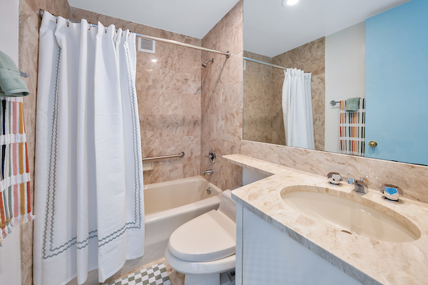 100 United Nations Plaza, Unit 8A Manhattan, NY 10017 - Photo 9 of 12 a bathroom with a granite countertop sink toilet and shower