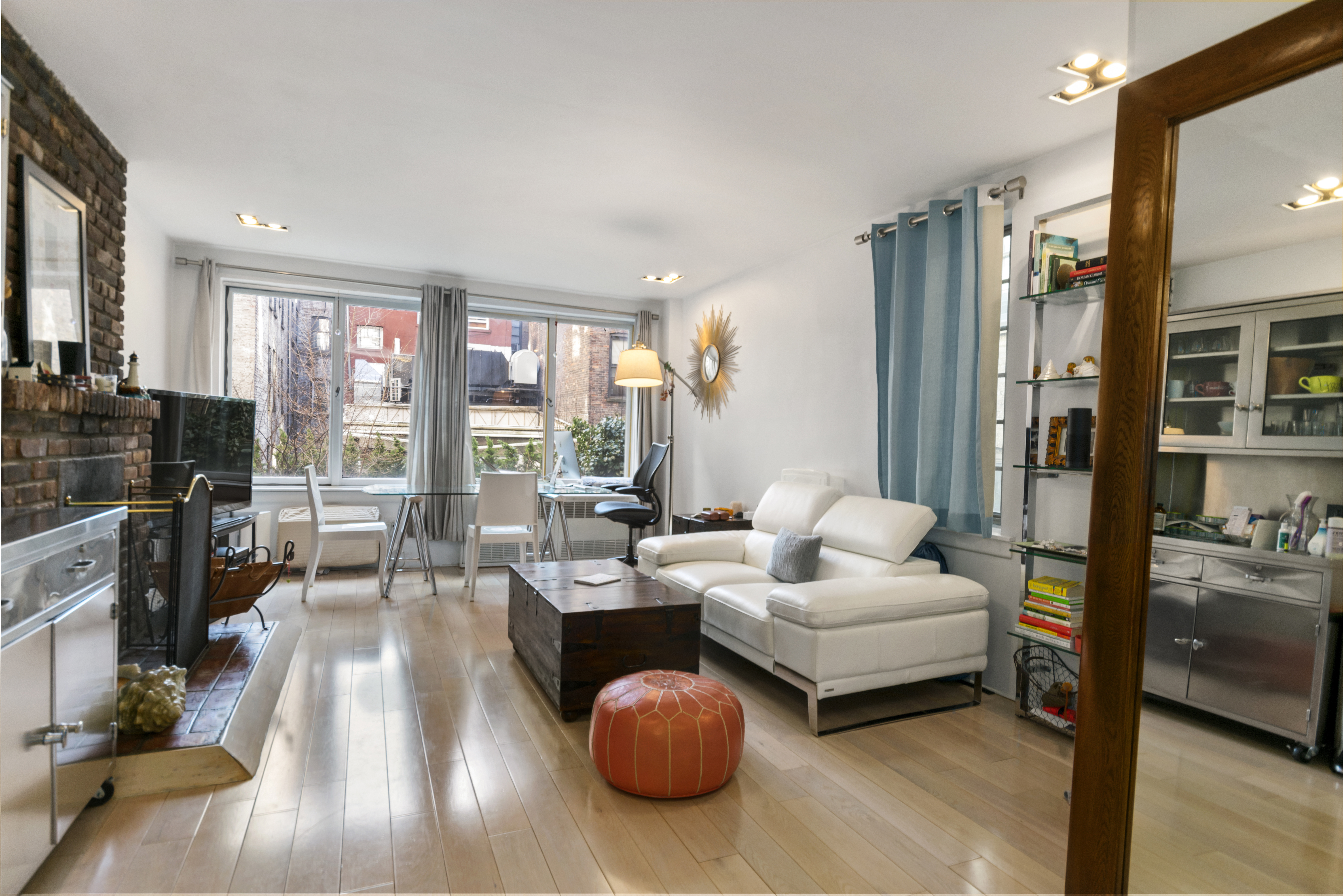 10 Charles Street, Unit 2B Manhattan, NY 10014 - Photo 2 of 8 a living room with furniture fireplace and flat screen tv