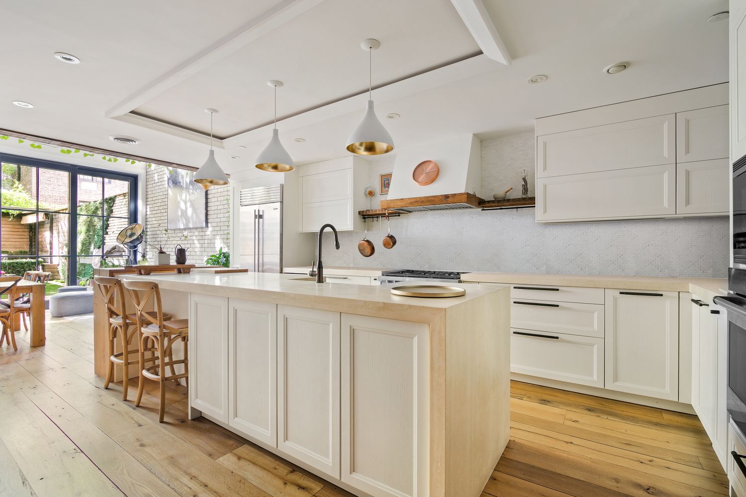 a kitchen with stainless steel appliances granite countertop a sink and cabinets with wooden floor