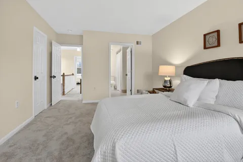 a bedroom with a bed and a night lamp