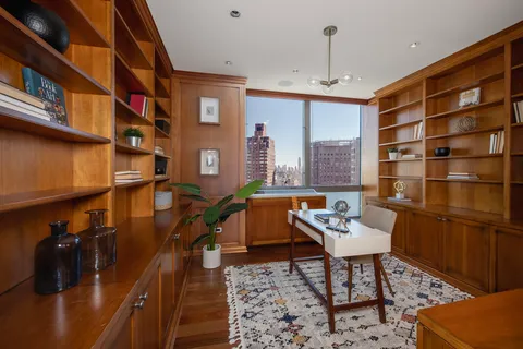 a reading room with furniture wooden floor and a book shelf