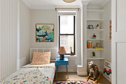 a bedroom with furniture and a window