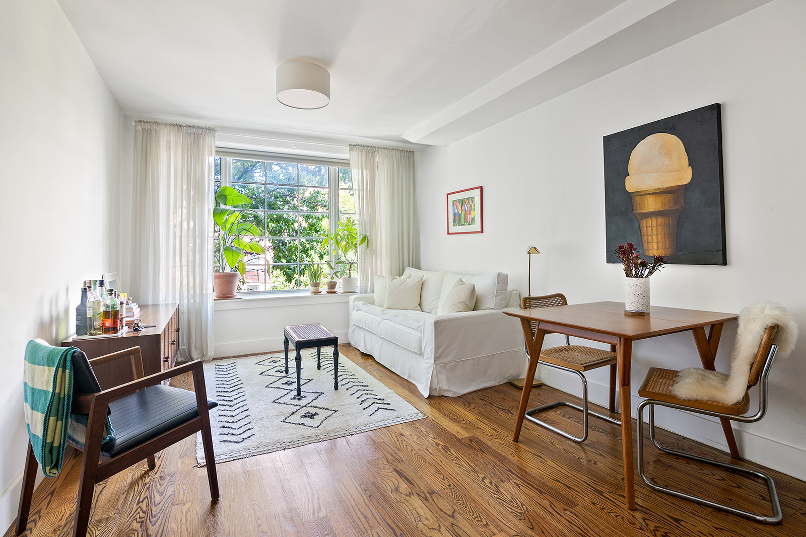 366 Gates Avenue, Unit 3A Brooklyn, NY 11216 - Photo 2 of 8 a living room with furniture and a window
