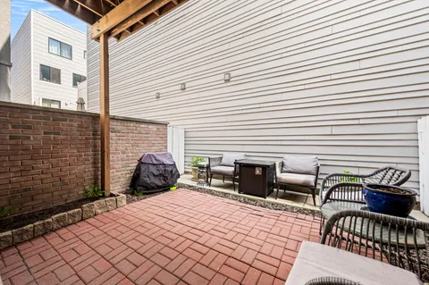 a front view of a house with outdoor seating