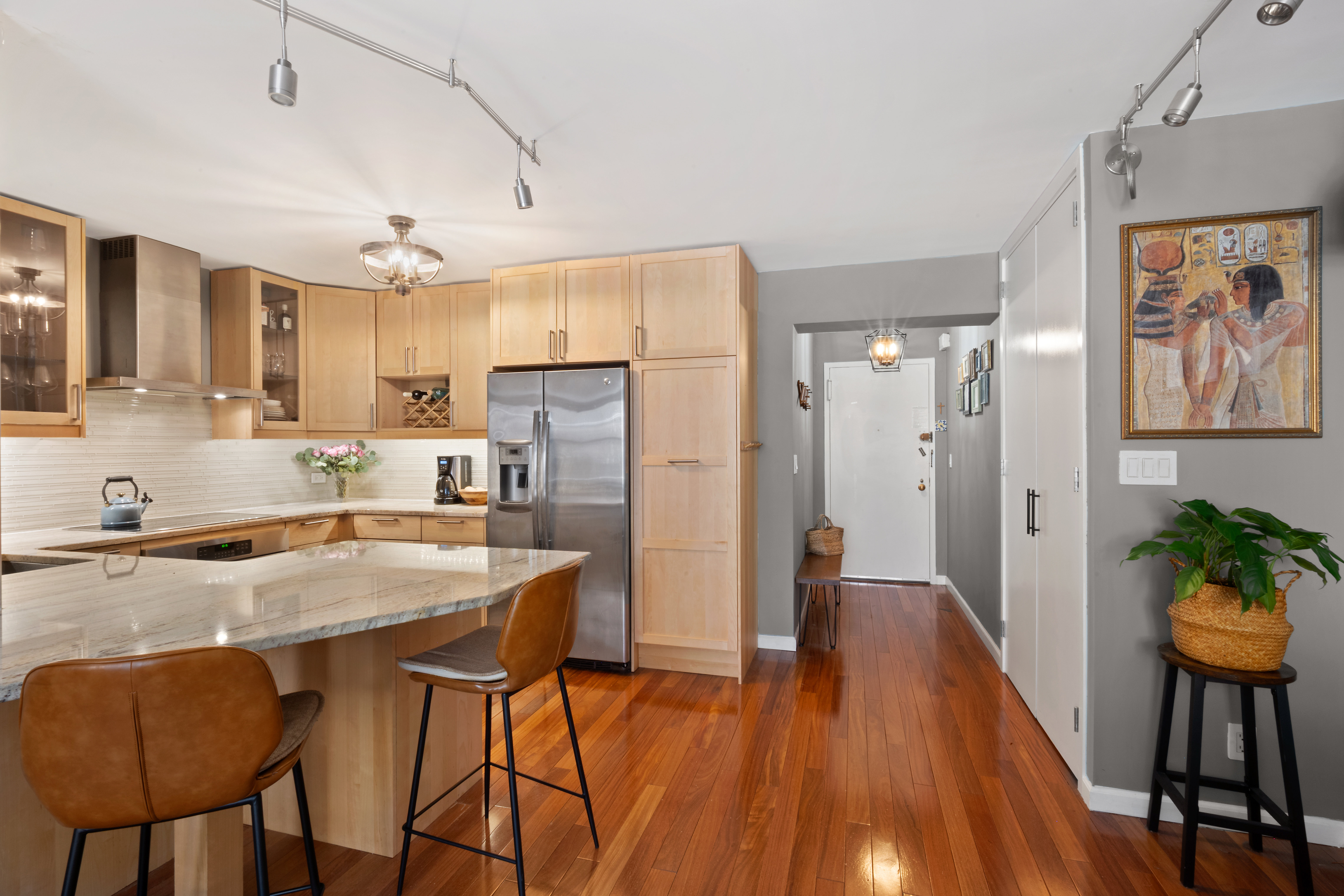 137 East 36th Street, Unit 8H Manhattan, NY 10016 - Photo 5 of 13 a kitchen with stainless steel appliances granite countertop a refrigerator a stove a sink dishwasher and white cabinets with wooden floor
