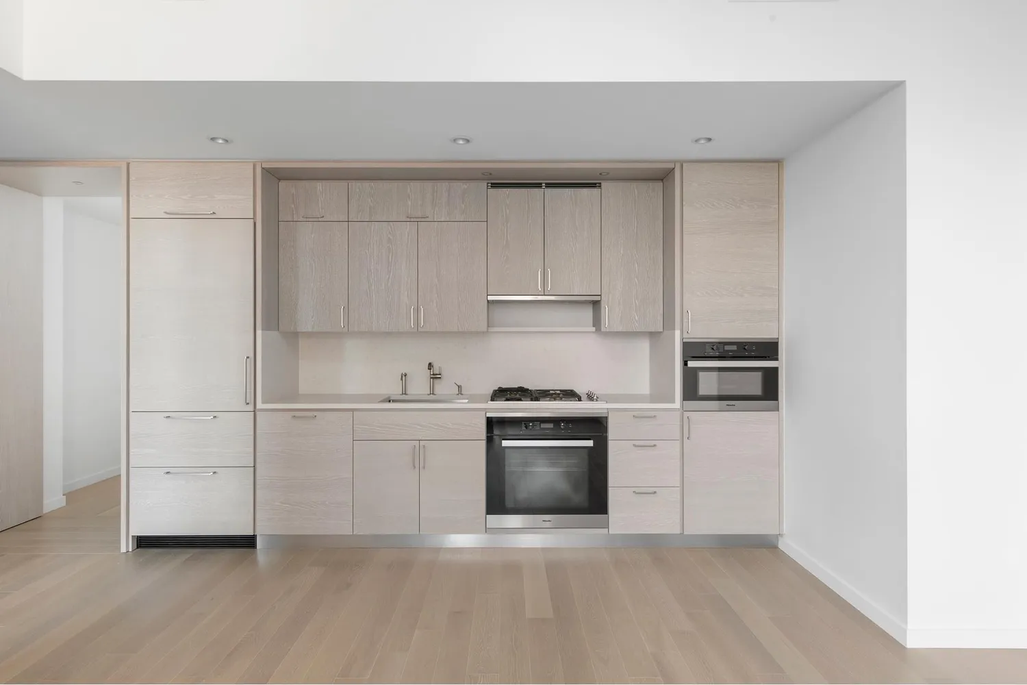 a kitchen with cabinets and stainless steel appliances