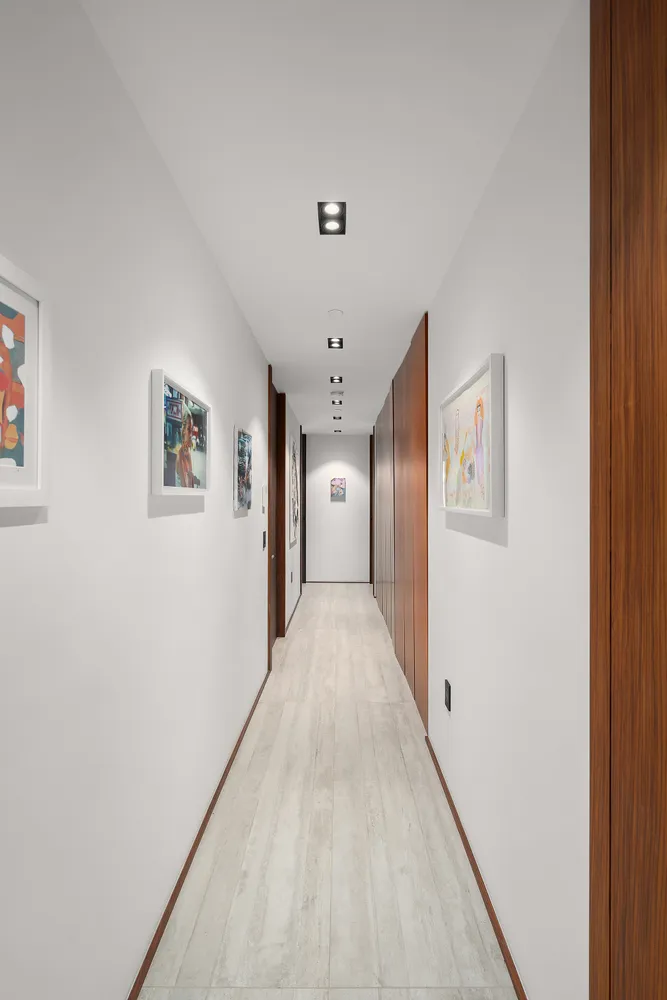 a view of hallway with wooden floor