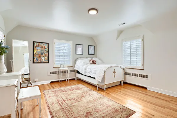 a bedroom with a bed and a desk