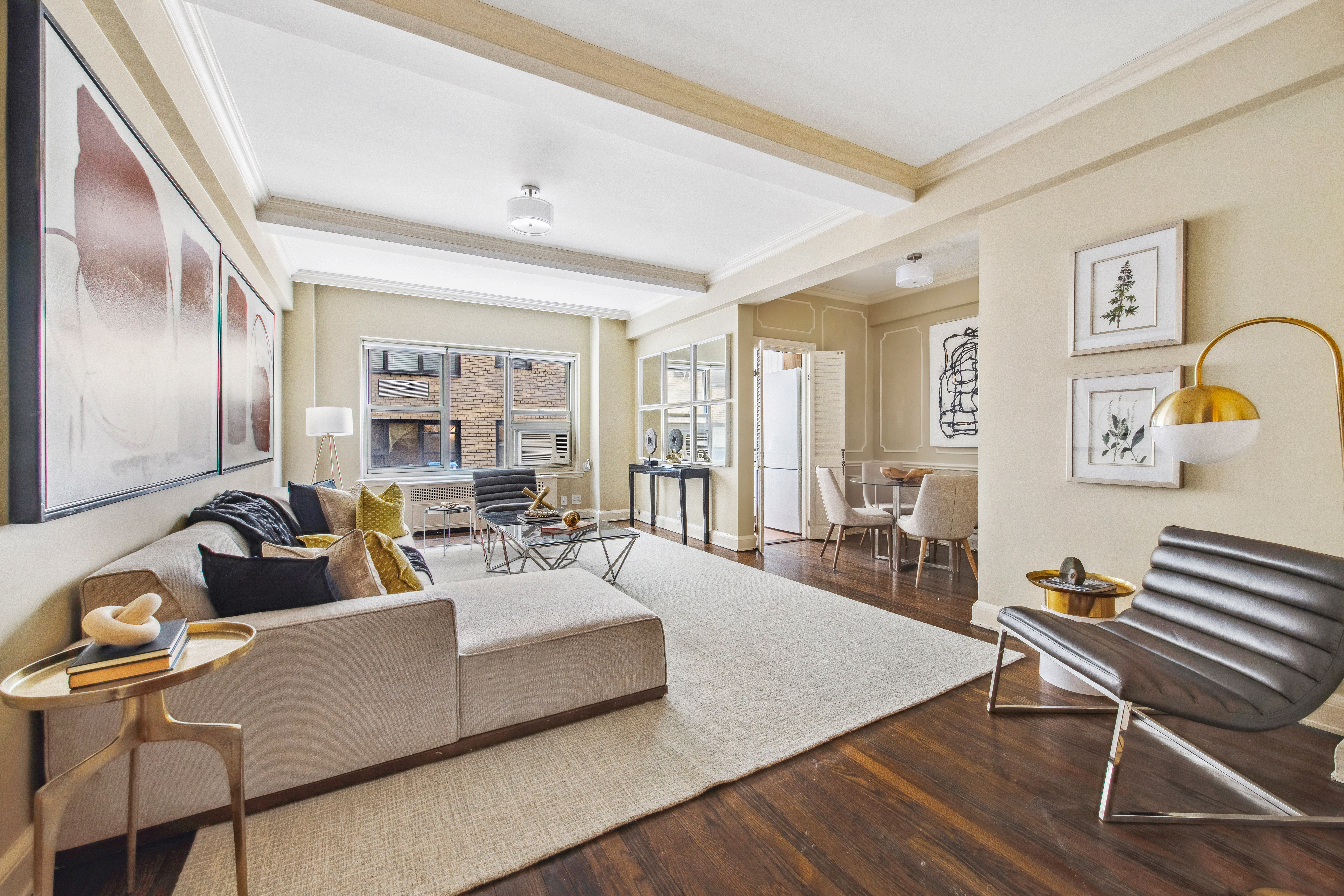 400 East 52nd Street, Unit 6K Manhattan, NY 10022 - Photo 1 of 8 a living room with furniture and wooden floor