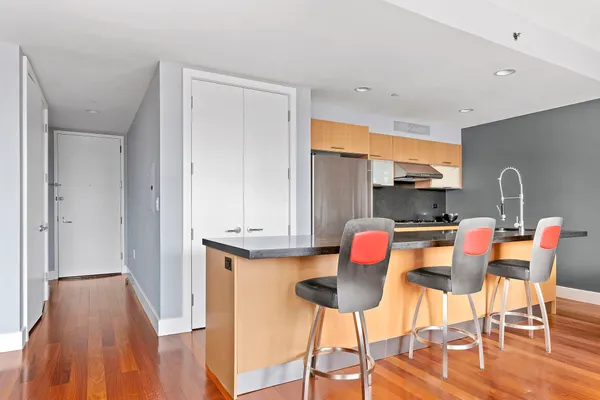a dining room with furniture and wooden floor