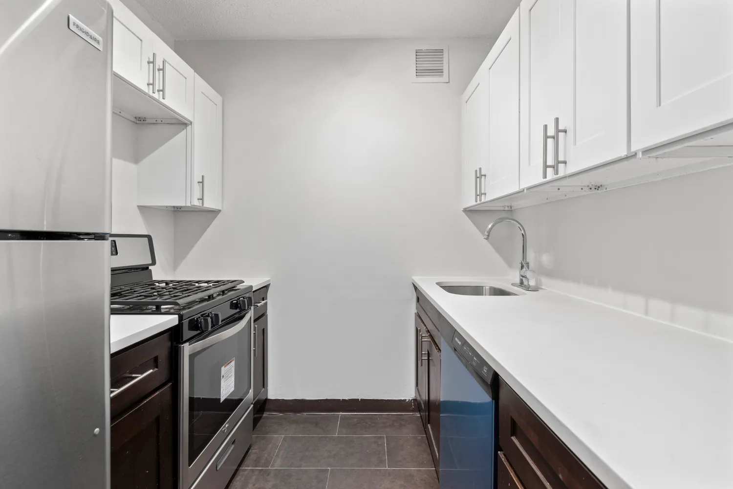 a kitchen with stainless steel appliances granite countertop a sink stove and cabinets