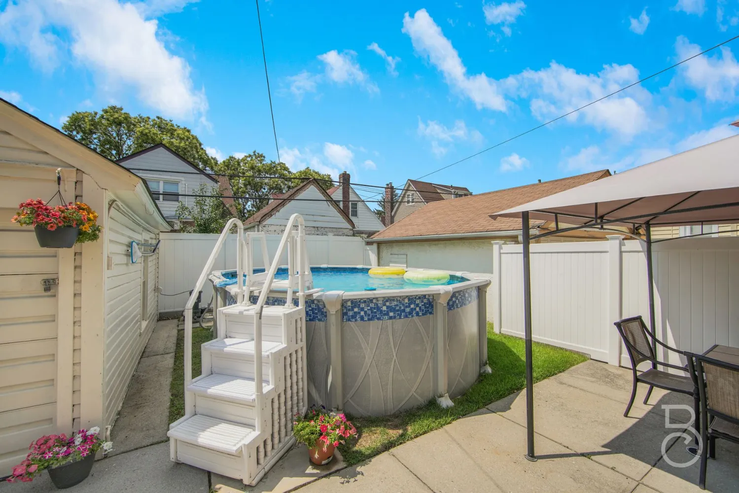 a view of a patio with table and chairs potted plants