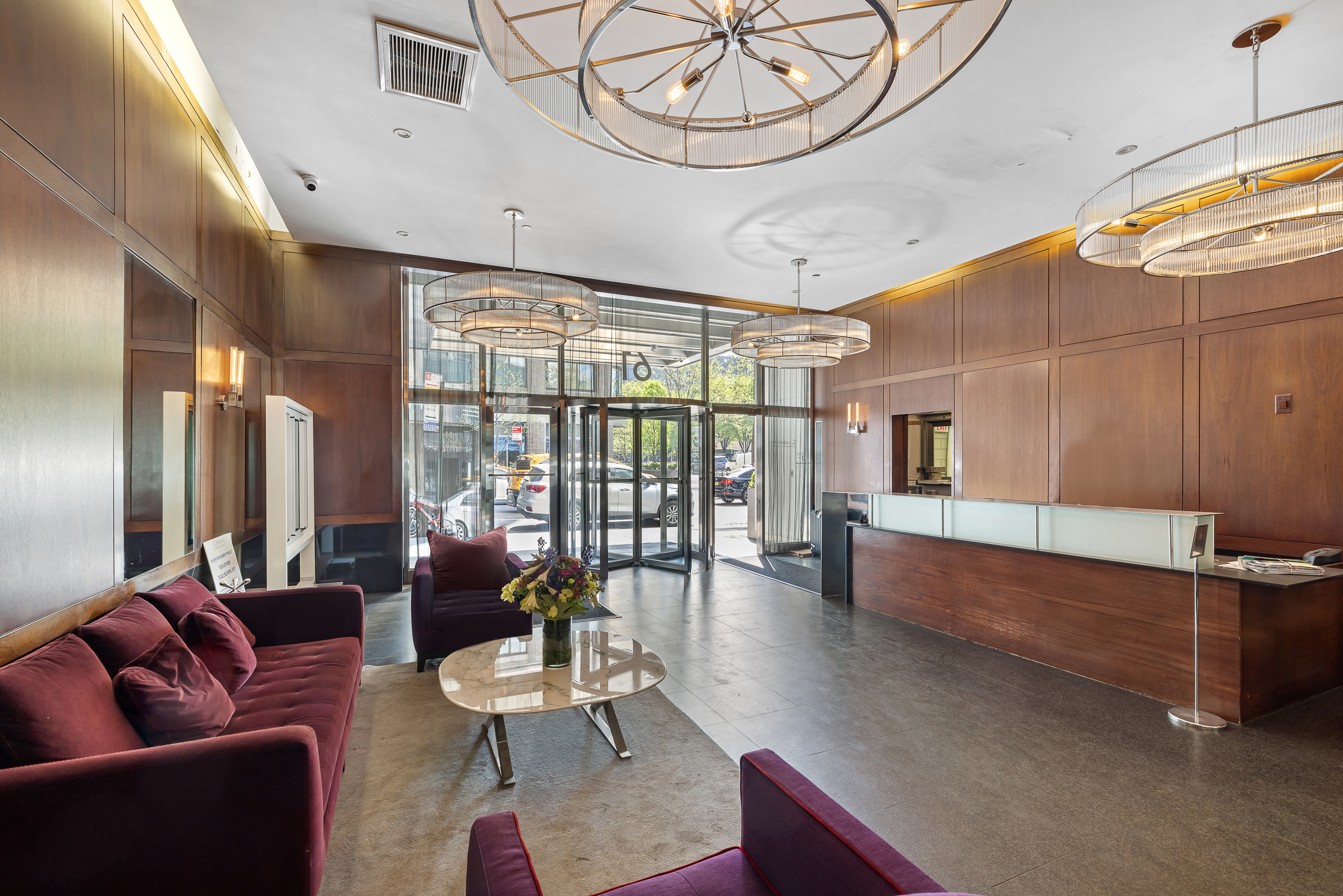 61 West 62nd Street, Unit 19C Manhattan, NY 10023 - Photo 6 of 7 a living room with furniture and a large window