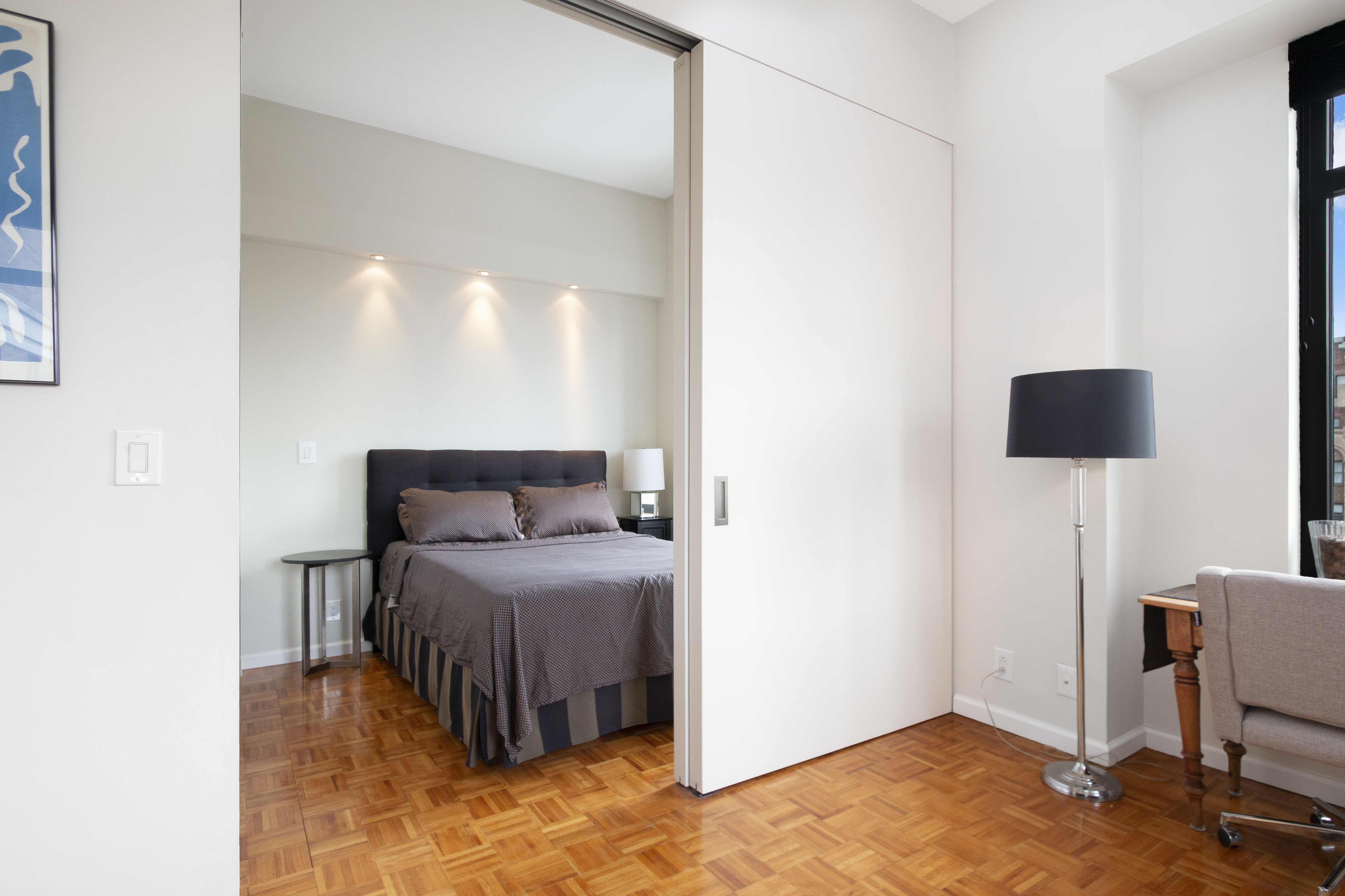 222 Riverside Drive, Unit PH2E Manhattan, NY 10025 - Photo 6 of 18 a bedroom with a bed and a table in it