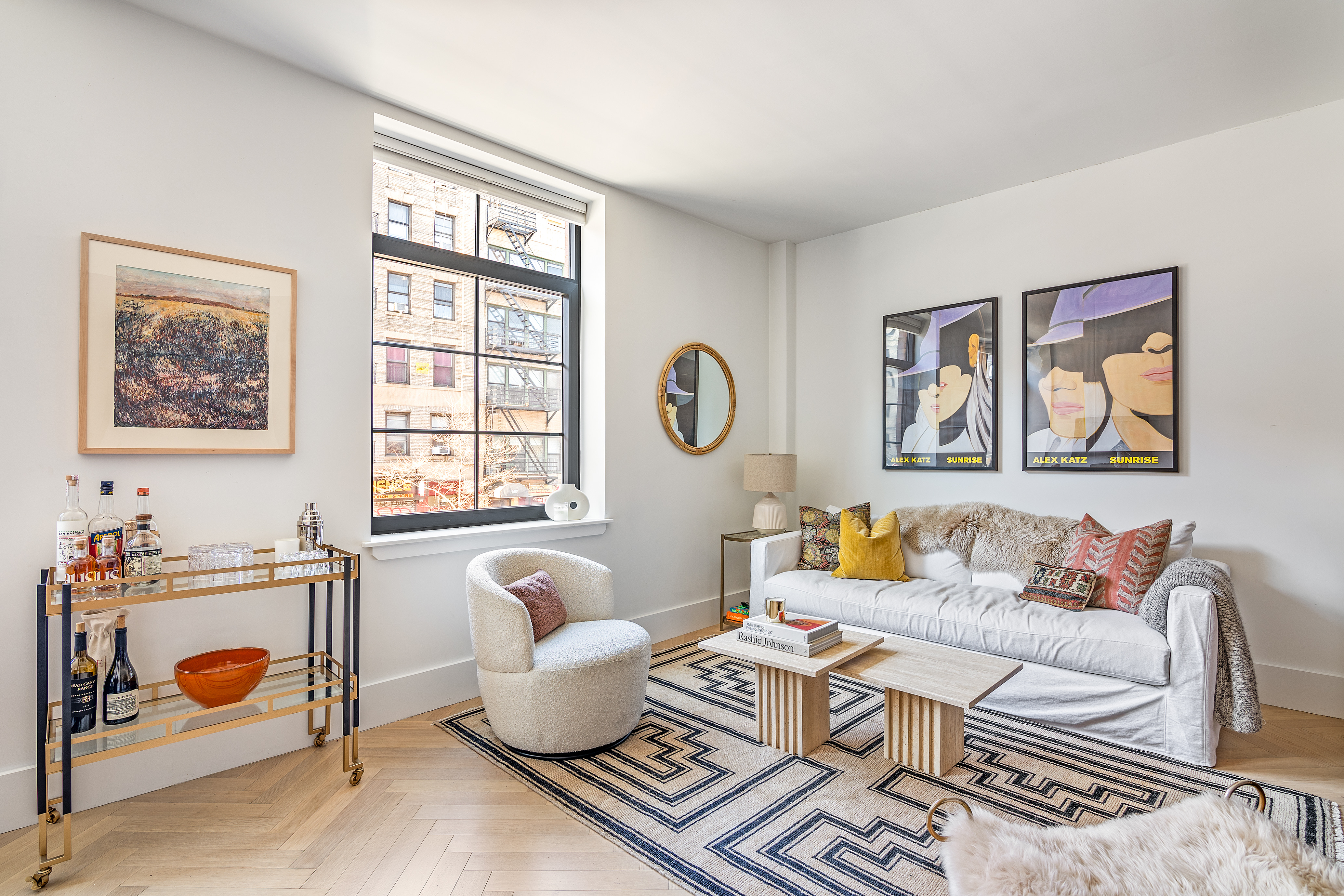 a living room with furniture a couch and wall paintings